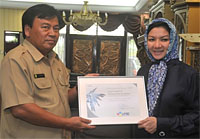 Kepala Diskominfo Kukar H Surip S menyerahkan piagam penghargaan LPSE Kukar kepada Bupati Rita Widyasari