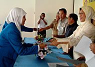 Ketua Jurusan D-3 Kebidanan Nina Maryana menyerahkan surat kelulusan kepada bidan asal Kukar